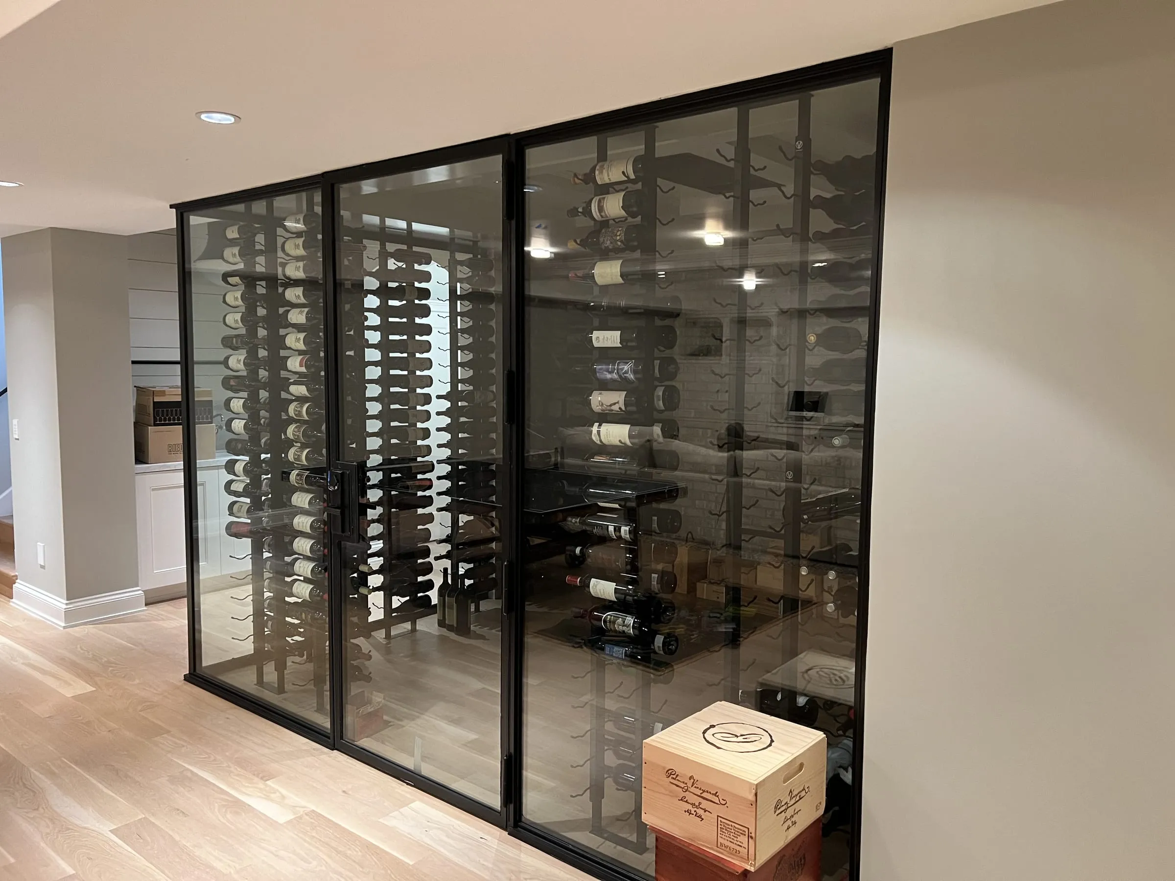 Front of the glass wine cellar with its glass door and wine racks
