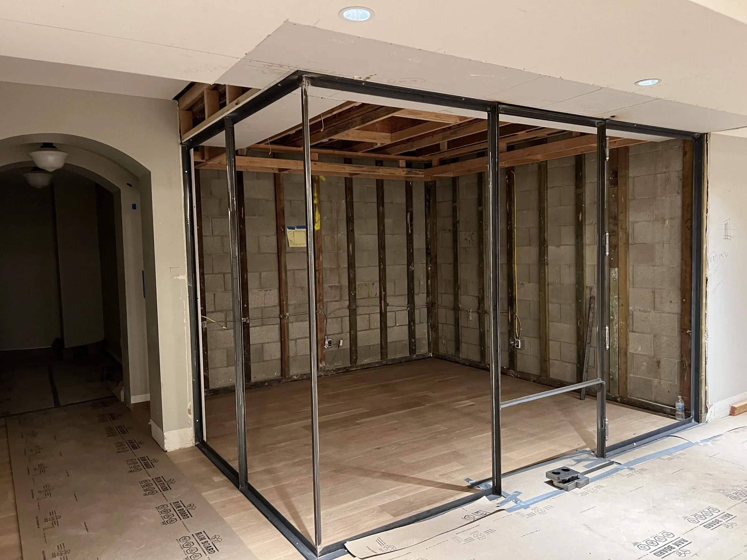 Black metal frame of the wine cellar before the glass was installed
